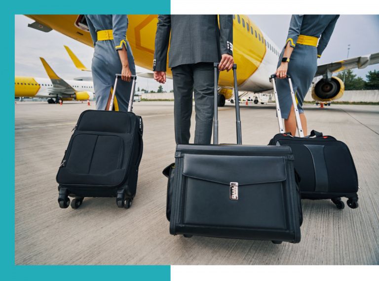 a group of people with luggage walking to an airplane
