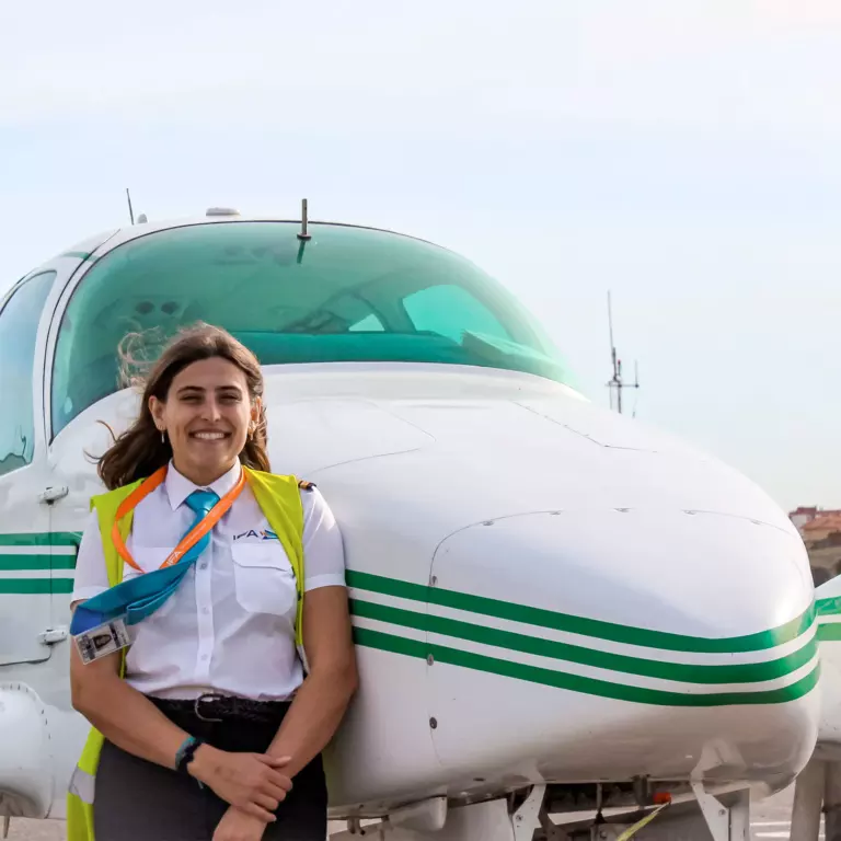 women pilot student near aircraft